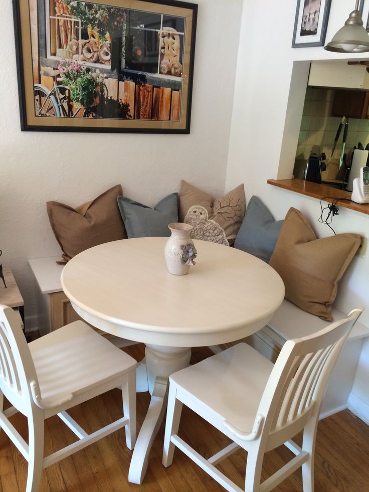 a white table with four chairs around it