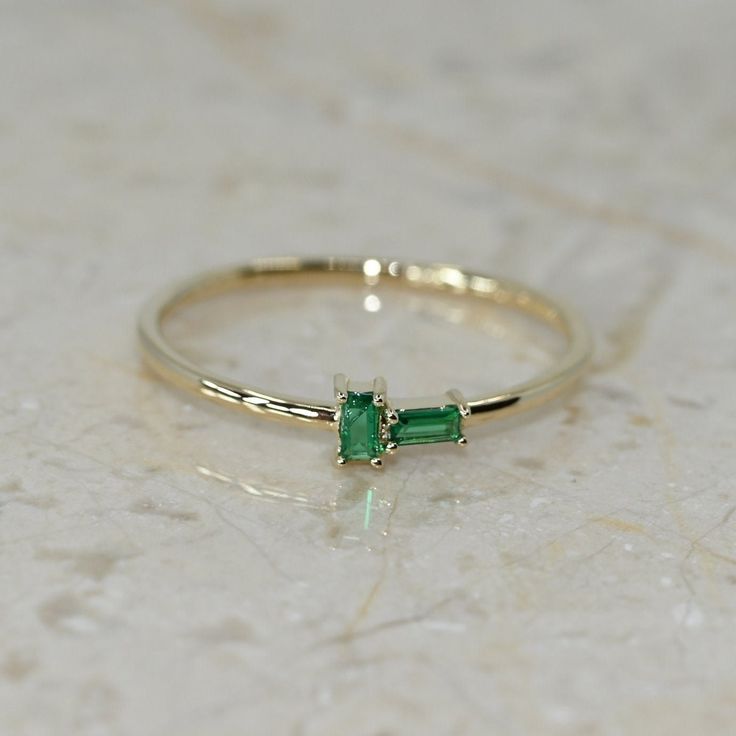 14k Solid Gold Birthstone Baguette Ring. Real Gold Dainty Stackable Bitystone Band. Premium Fine Jewelry For Her. 💙 Our jewelry is handcrafted with love and great care at San Francisco Bay! All of our items are 14k stamped for authenticity. 💙 You will receive them exactly as pictured. We don't use any filters, all photos are authentic and unedited.  💙 Dimensions - Band Width: 1.10 mm. Figure Height: 4.50 mm, Figure Length: 9.20 mm.  💙 The ring material is 14k Solid gold, should not be confused with gold plating or filling. It won't tarnish or fade over time. 💙 We're offering the finest quality in solid gold jewelry. 💙 Quick shipping - Your order will be handcrafted and shipped in a few days. 🎁 They are delivered in a nice jewelry box, ready to be presented as a precious gift. 💙 We Emerald Baguette Ring, Emerald Statement Ring, Emerald Band Ring, Emerald Wedding Band, Alexandrite Jewelry, Emerald Band, Baguette Ring, Handmade Fine Jewelry, Ruby Jewelry