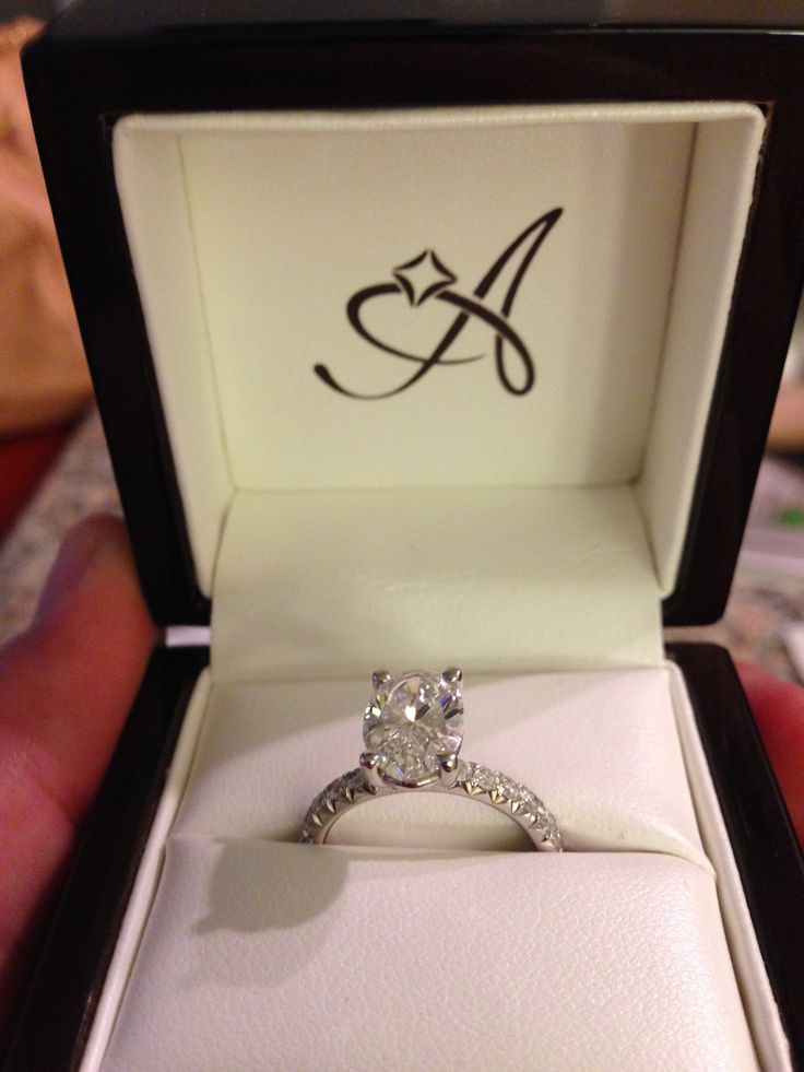 an engagement ring in a box with the letter a on it's front and side