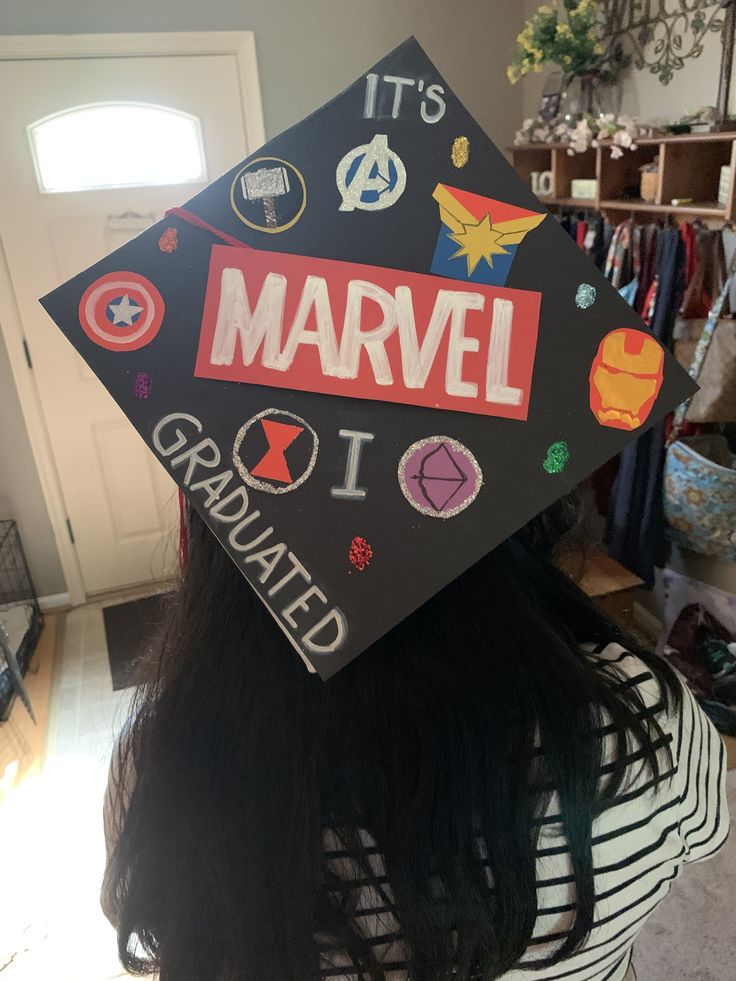 a woman wearing a graduation cap with the words, it's marvel i graduated