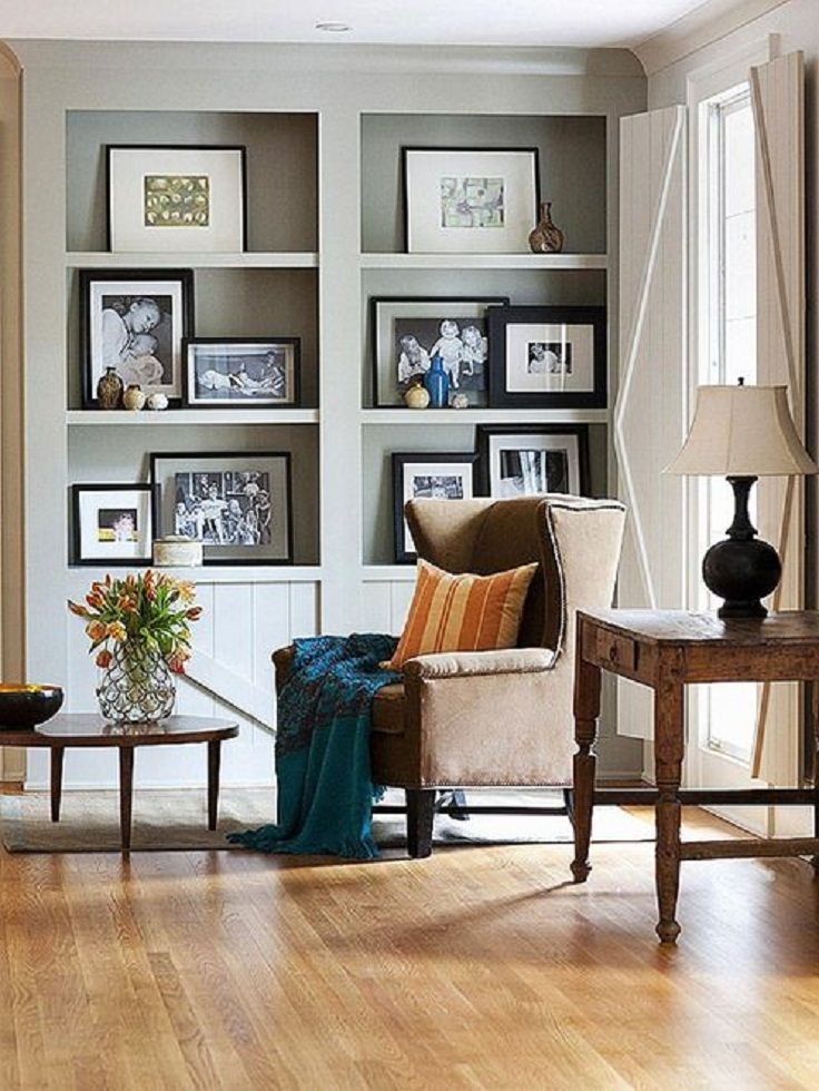 a living room filled with furniture and pictures on the wall