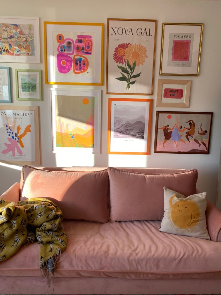 Gallery wall of bright colorful prints with a pink sofa featured Fun Living Room Wall Decor, Picture Wall Ideas Colorful, Bedroom Inspirations Pink Walls, Colored Frames On Wall, Colorful Collage Wall, Colorful Picture Frame Gallery Wall, Colorful Photo Wall, Wall Art Collage Living Room, Fun Gallery Wall Ideas