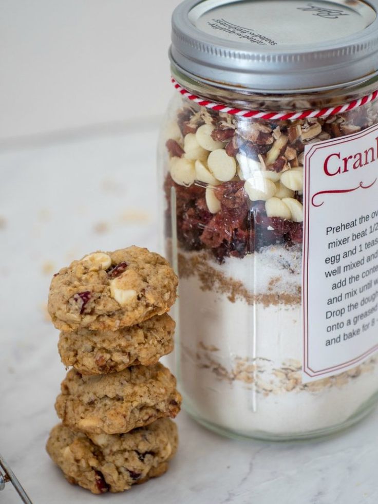 cookies and granola in a glass jar next to a spoon