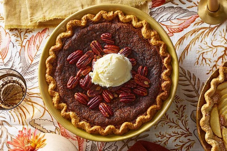 a pie with pecans and ice cream on top