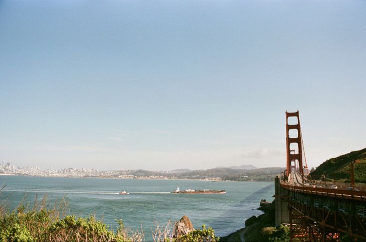 the golden gate bridge in san francisco, california is seen from across the bay on a sunny day