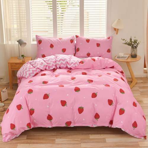 a pink bed with strawberry print on it