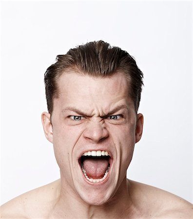 a man with his mouth open and an angry look on his face