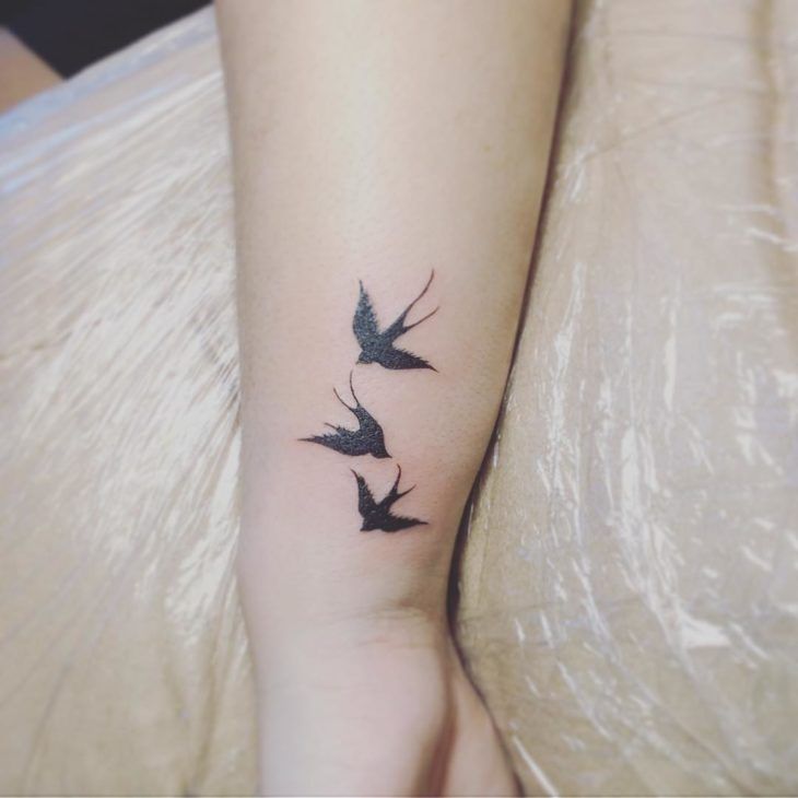 three birds tattoo on the left ankle