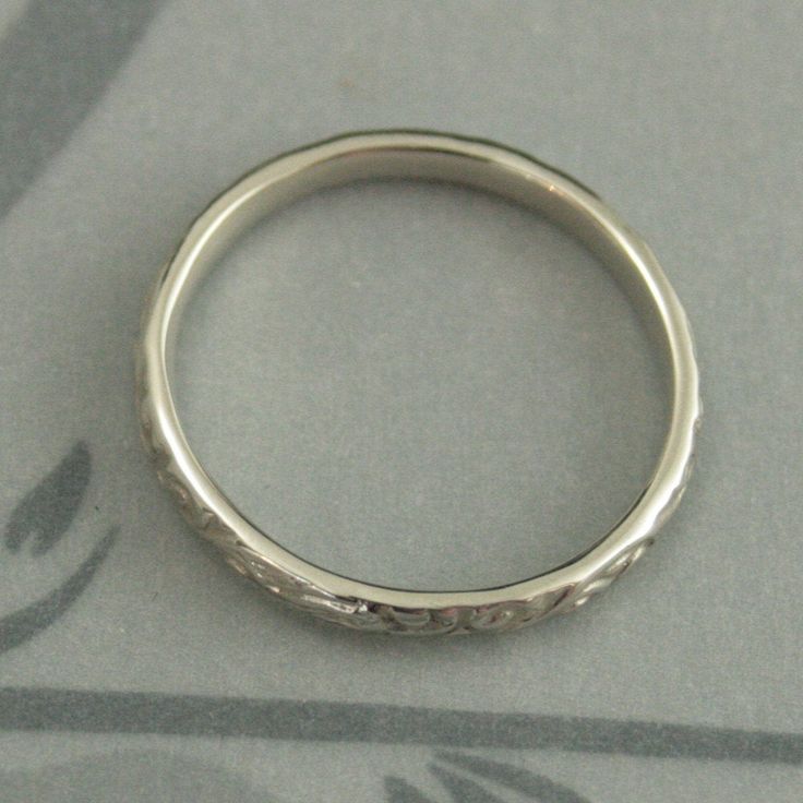 White Gold Skinny Flourish Band Women's Wedding Band Women's White Gold Band Vintage Style Band Antique Style Ring White Gold Wedding Band This is a slimmer version of our Flourish Le Femme band: https://www.etsy.com/listing/151251996 And our Flourish Wide: https://www.etsy.com/listing/179128813 At a dainty 2.4mm wide by 1.5mm thick, this is the perfect thinner wedding band or stacking ring. You simply can't do without it! Pair it with your other stacking rings or wear it alone as a symbol of yo White Gold Wedding Ring With Decorative Band, White Gold Round Band For Wedding, White Gold Round Wedding Band, Heirloom Wedding Ring With Decorative Band, Heirloom Wedding Band Adjustable, Heirloom Silver Wedding Bands, Wedding Bands With Diamond Cut In Silver, Silver Wedding Bands With Diamond Cut, Silver Diamond Cut Wedding Bands