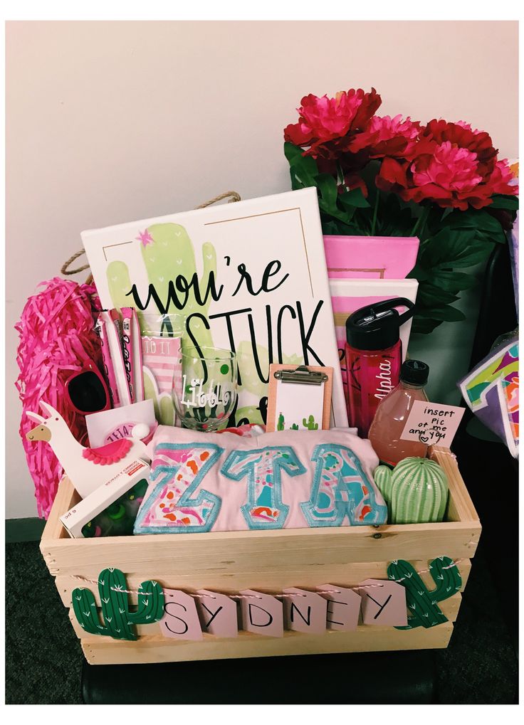 a wooden box filled with personal care items next to pink flowers and other things in it