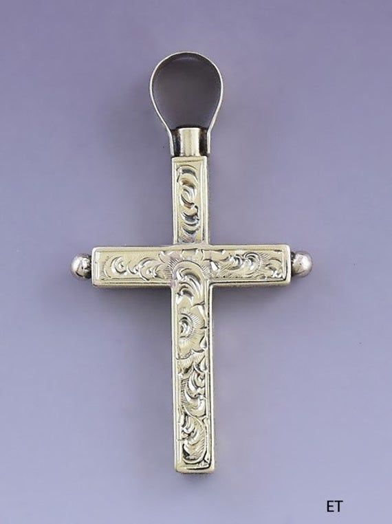 Presented is a fabulous 14 karat gold watch key fob or pendant in the form of a cross. This piece dates to around the 1850s-1870s and is likely of European make, possibly Swiss or French. The cross is beautifully hand engraved on all sides, with delicate scrolled foliate designs on the front and back and diamond diaperwork on the sides. The cross slides up to reveal a watch key end, about a size 7 by our estimate, compared to example watch keys in varying sizes. This is a really exceptionally we Antique Collectible Cross Jewelry, Antique Cross Jewelry With Large Pendant, Historical Yellow Gold Engraved Jewelry, Antique Cross Pendant Jewelry With Intricate Design, Antique Collectible Crucifix Jewelry, Victorian Engraved Crucifix Jewelry, Antique Crucifix Collectible Jewelry, Formal Engraved Crucifix Jewelry, Antique Hallmarked Cross Pendant Jewelry