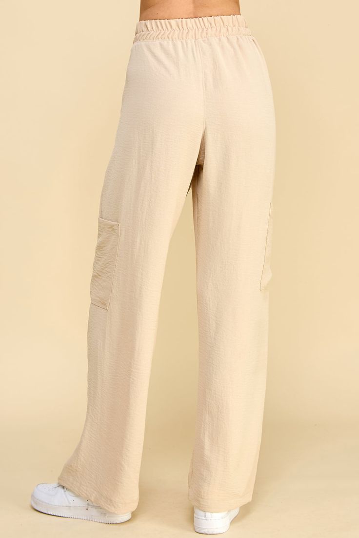 Looking for a stylish and comfortable way to update your look? Check out Sahar Pants! Made with high waist and front pleats, these pants give you a modern, polished look. Side pockets make it easy to carry your essentials with you, while cargo pockets add an extra touch of functionality. With a versatile style that can be dressed up or down, Sahar Pants are a must-have addition to any wardrobe. Materials & Care - Content: 100% Polyester- Care: Machine wash cold, tumble dry low, cool iron if need Utility Harem Pants With Cargo Pockets, Relaxed Fit Wide Leg Bottoms With Cargo Pockets, Wide Leg Bottoms With Cargo Pockets And Relaxed Fit, Relaxed Fit Wide Leg Harem Pants With Cargo Pockets, Utility Wide Leg Harem Pants With Pockets, Chic Straight Cargo Parachute Pants, Chic Cargo Style Straight Parachute Pants, High Waist Wide Leg Cargo Pants For Work, Chic High-waisted Parachute Pants With Cargo Pockets