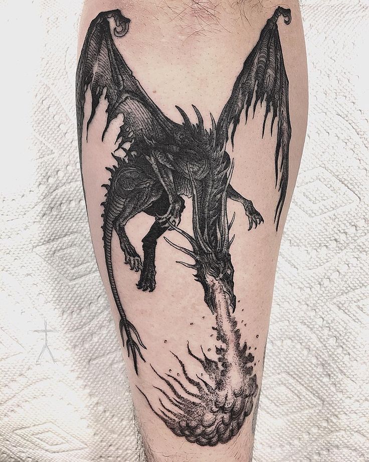 a black and white photo of a dragon on the leg