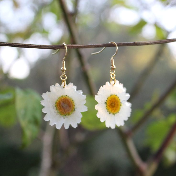 About the DAISY FLOWER, symbol of purity and innocence: This pretty white flower with a yellow heart evokes innocence, candor and purity. Delicate and feminine, it is the symbol of youth, of true love, but also of fidelity. Your earrings are made from real, genuine dried and pressed Daisies flowers, envelopped by a layer of resin and a 14k gold plated earwire.  Your jewelry is handmade with love in the south of France. It is sent to you with tracked delivery, and comes packaged in a small environmentally friendly gift box. ♡ Minimalist Flower Shaped Pierced Jewelry, Minimalist Birth Flower Earrings, Dainty White Dangle Flower Earrings, White Nature-inspired Drop Earrings, White Sterling Silver Pierced Flower Earrings, Nature-inspired White Drop Earrings, Handmade White Sterling Silver Flower Earrings, Delicate White Hypoallergenic Jewelry, Minimalist White Flower Earrings For Gift