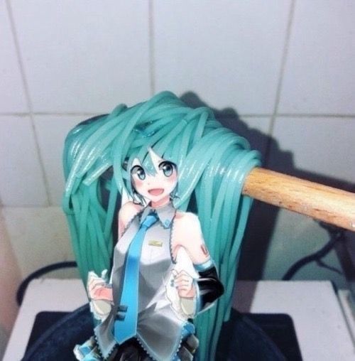 a close up of a figurine holding a baseball bat on top of a stove