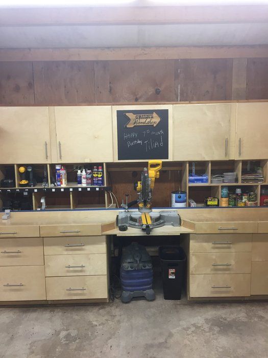 a garage with lots of cabinets and tools