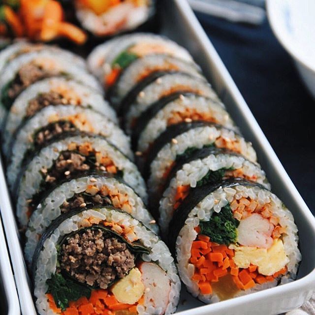 there are many sushi rolls in the tray