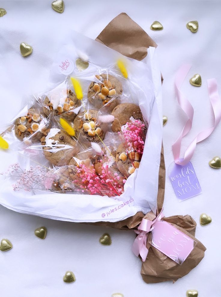 a bag filled with lots of food on top of a white table covered in confetti