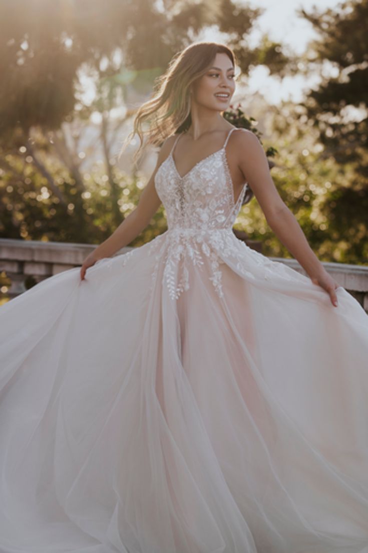 a woman in a wedding dress posing on a bridge