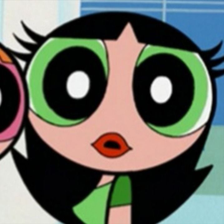 an animated girl with big eyes holding two pink and green circles in front of her face