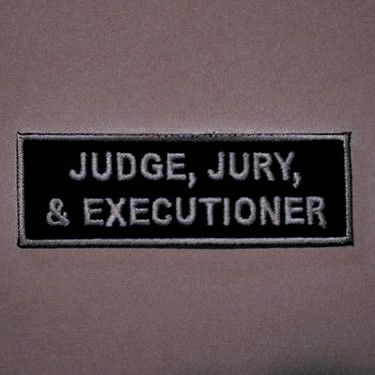 a black and white sign that says judge, july & executive on the side of a wall