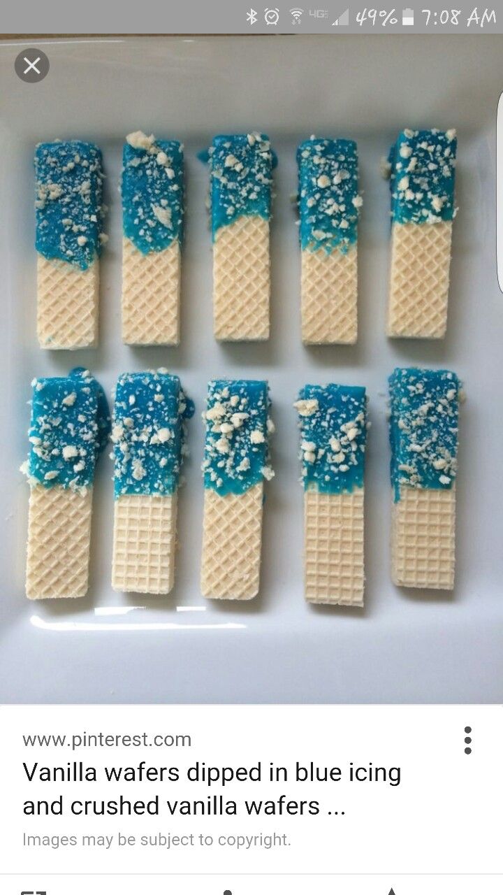 blue and white waffles are arranged in rows on a plate, with the words vanilla waffles dipped in blue icing and crushed vanilla wafers