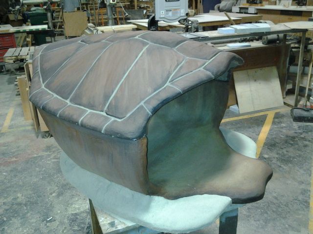 a chair that is sitting in the middle of a workbench and being worked on