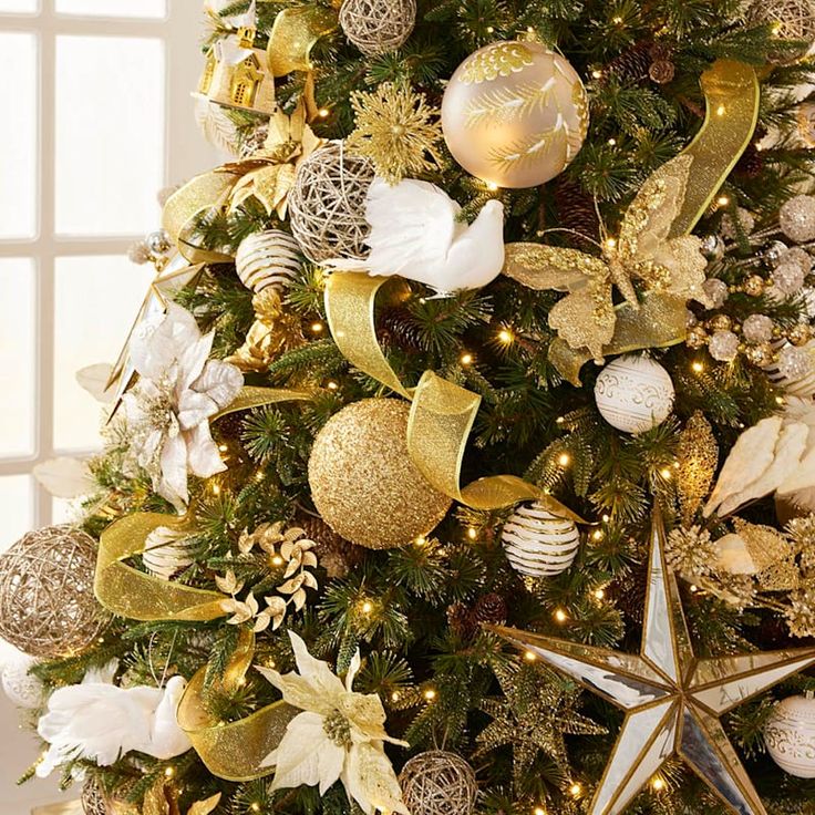 a christmas tree decorated with gold and white ornaments