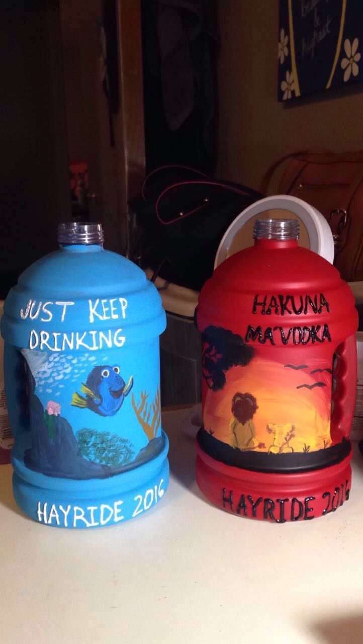 two colorful water bottles sitting on top of a table