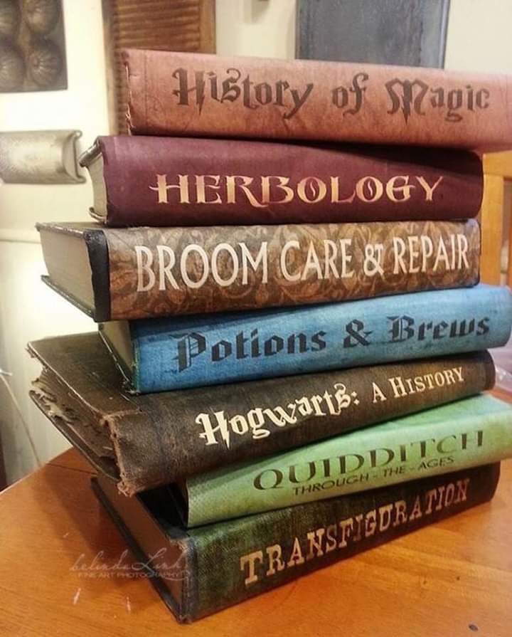 a stack of books sitting on top of a wooden table