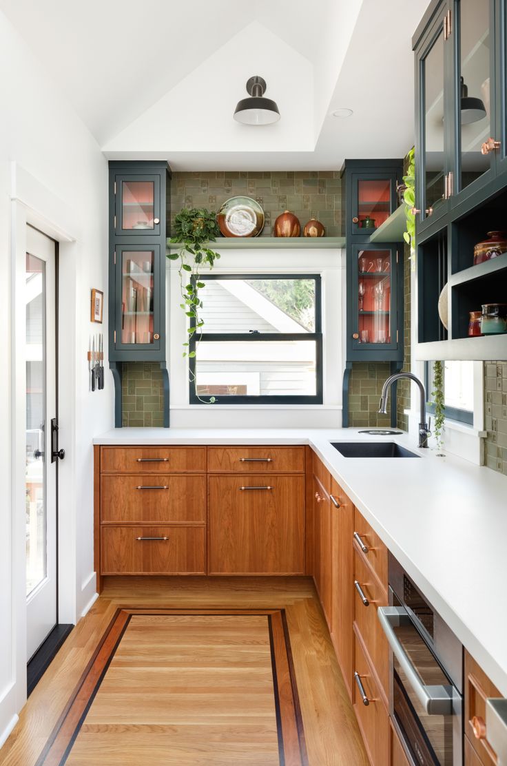 the kitchen is clean and ready for us to use it's natural wood flooring