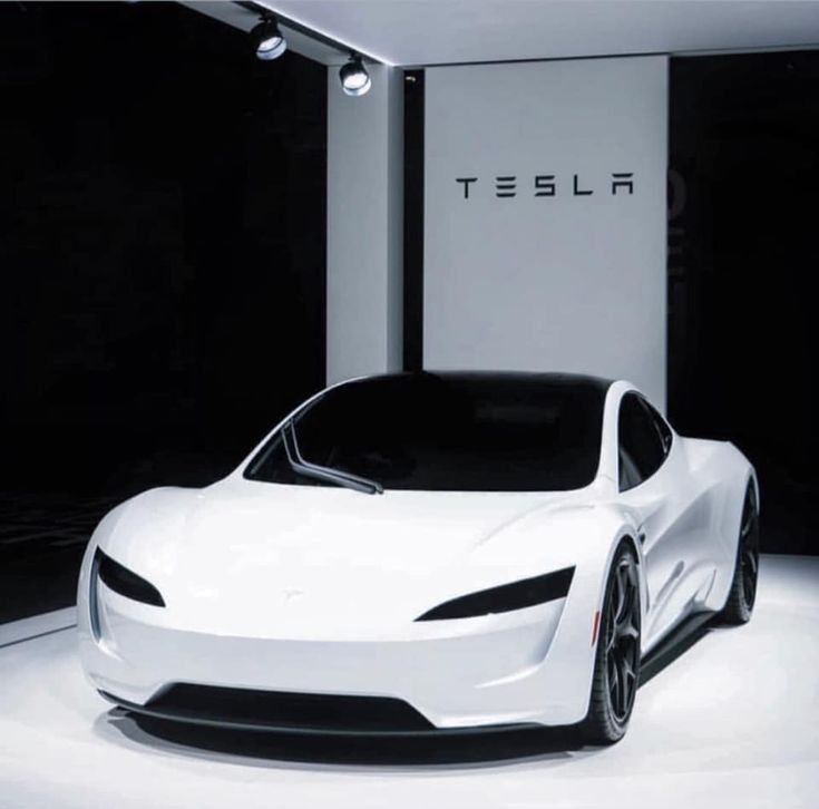 a white tesla sports car is on display