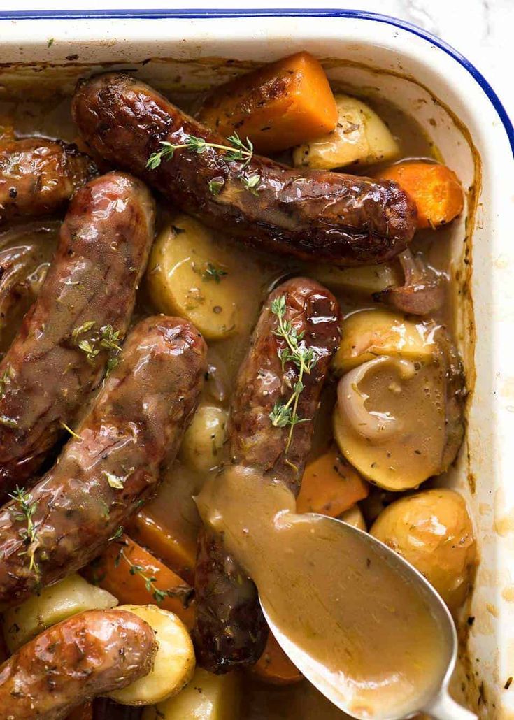 sausages, potatoes and carrots in a casserole dish