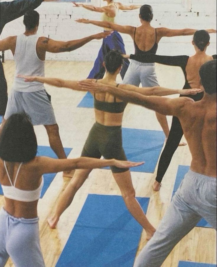 a group of people standing in a circle doing yoga