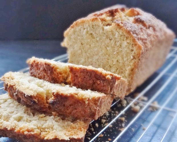 sliced loaf of bread sitting on top of a cooling rack