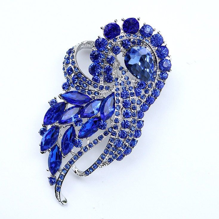 Elegant and stunning rhinestone blue brooch rhinestone embellishment, which can be used for your DIY project - blue wedding bridal brooch bouquet, bridal or prom gown sash, necklace, ring pillow, cake and frame decorations, event decor, crafts, scrap booking and much more.  Size: 3 1/2 inch high 2 inches wide Metal: Silver plated This crystal royal blue broach can be ordered with pin in the back to add to wedding gown or dress sash, to wire into brooch bouquet, or any number of other craft projects; or without the pin as a flat back embellishment for your sew-on, glue-on DIY project. More ROYAL BLUE brooches - https://www.etsy.com/shop/Crystalitzy?section_id=16200394&ref=shopsection_leftnav_4 Please note that this crystal rhinestone embellishment has flat backing, it is suitable only for y Diy Wedding Dress Sash, Mertensia Virginica, Brooches Diy, Pillow Cake, Sapphire Blue Weddings, Blue Brooch, Blue Sapphire Jewelry, Bridal Brooch, Bridal Brooch Bouquet