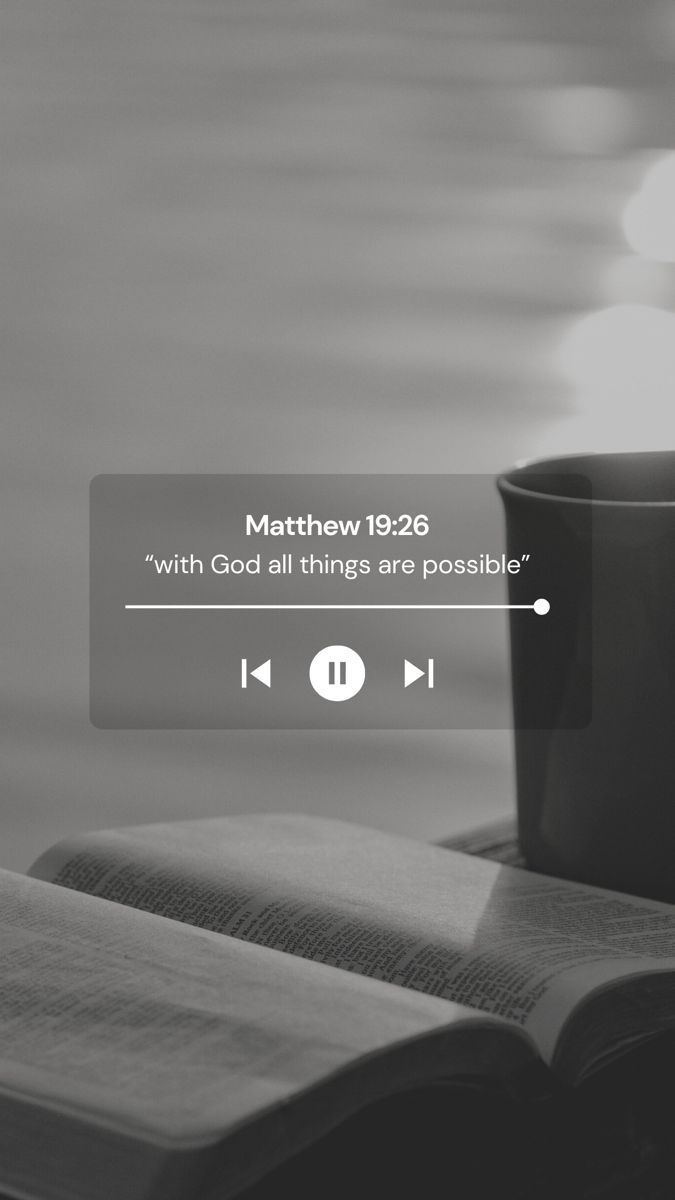 an open book sitting on top of a table next to a cup