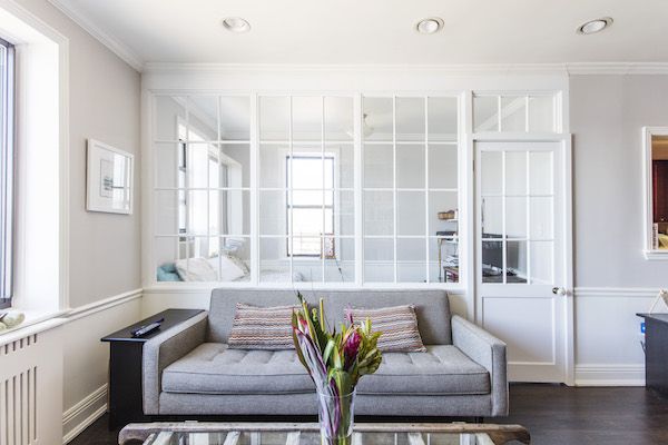 a living room filled with furniture and windows