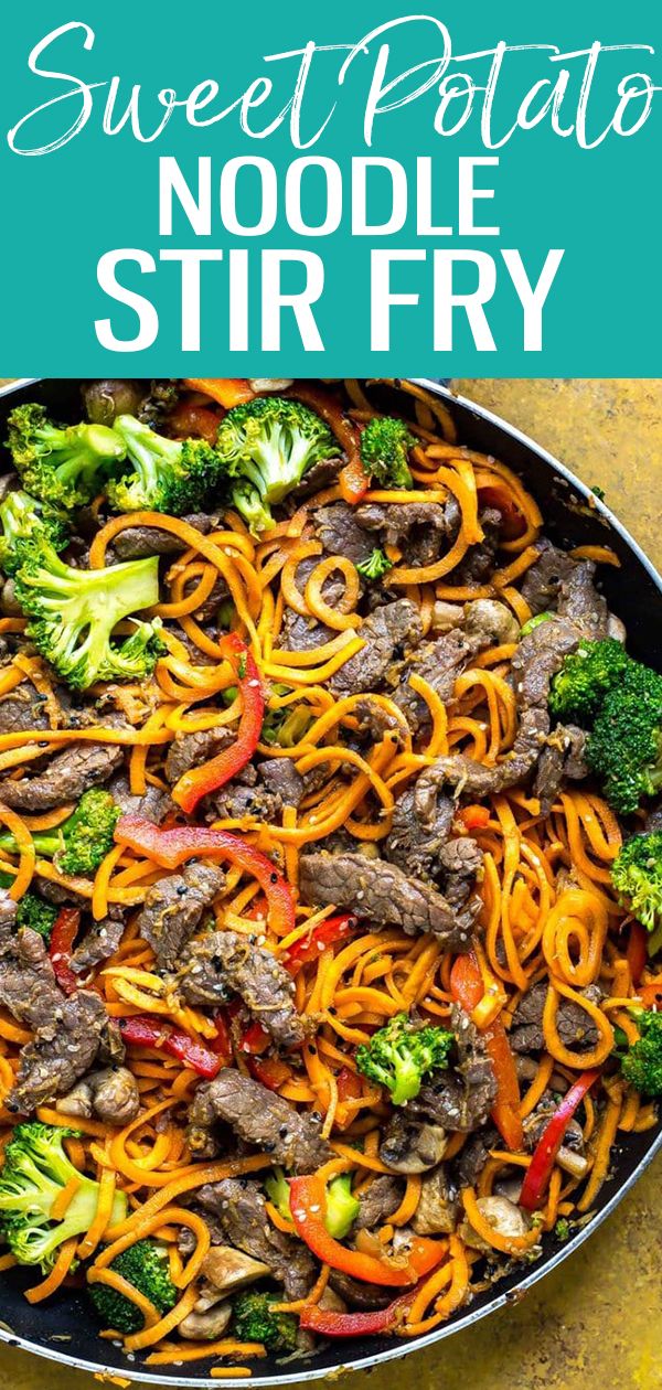 beef noodle stir fry in a skillet with broccoli and peppers