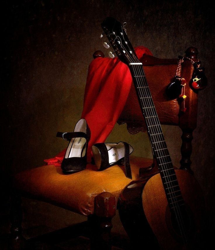 a pair of high heeled shoes sitting next to a guitar