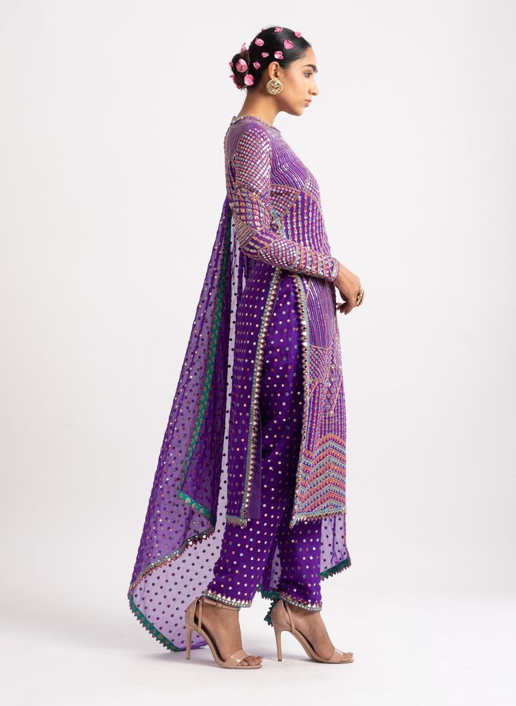 Editor's Note Intricately Hand Embroidered Multi Color Kurta With Fully Embroidered Pant And Dupatta With Mirror Border. Fabric: Georgette, Silk Blend Color: Purple Care: Dry Clean Only About the Designer Vvani by Vani Vats- an Indian ethnic women’s wear label. It is a depiction of the royal and intricate handcrafted embroideries in unconventional designs. Vani Vats, Embroidery Kurta, Mirror Border, Border Fabric, Indian Wedding Wear, Embroidered Pants, Rose Embroidery, Kurta Set, Wedding Wear