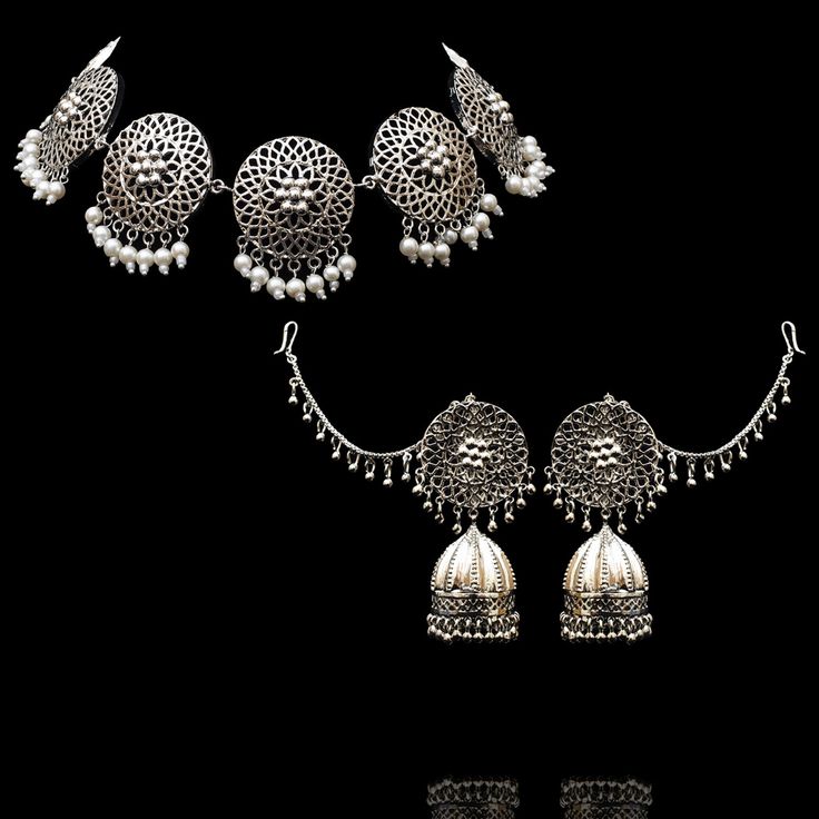 Be a trendsetter and ignite your inner fashionista with tribal accessories! Adorn our Rayen Set crafted with intricate filigree and pearl moti hanging. The set includes a necklace and a pair of stunning earrings with saharay. Approximate earrings length is 3". Designed over brass with silver oxidized finish. Made by order. Kindly allow 5-7 weeks for the delivery of this item. For custom or urgent requests, please contact support@alacouture.com. *Please Note: We use faux stones and beads in all o Navratri Earrings With Intricate Metal Design, Navratri Metal Earrings With Intricate Design, Traditional Filigree Jewelry For Navratri, Navratri Festive Filigree Jewelry, Bohemian Multi-strand Black Bead Jewelry, Unique Gift Cards, A Necklace, Faux Stone, Stunning Earrings