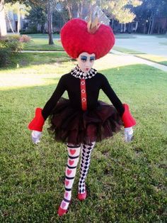 a doll with red hair and black dress in grass