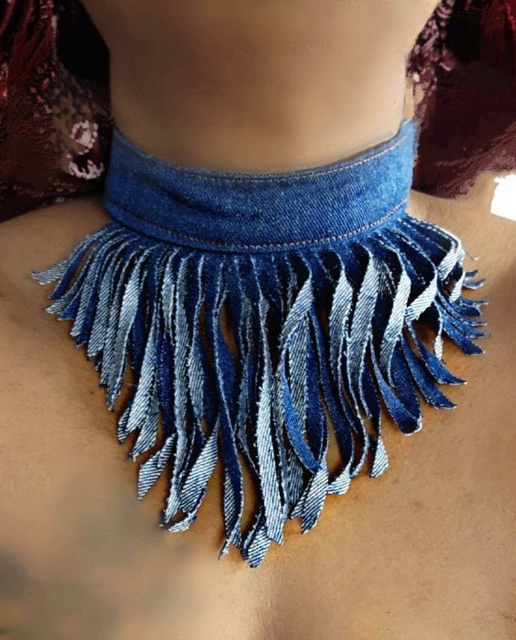 a woman wearing a blue necklace with fringes on it