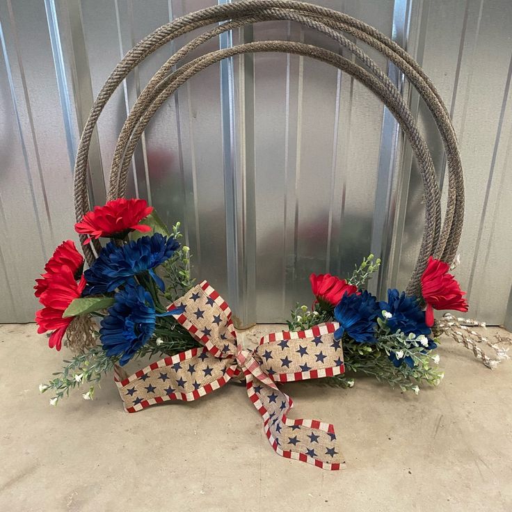 a patriotic wreath with red, white and blue flowers