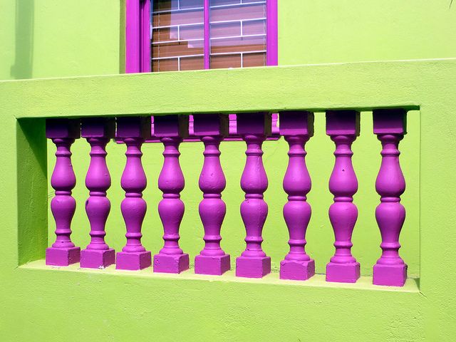 a green building with purple balconies on it