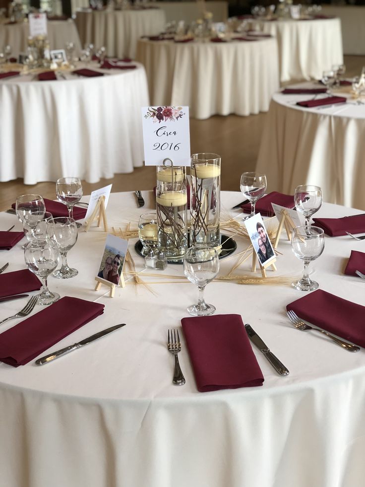 the table is set with wine glasses, silverware and place settings for guests to eat