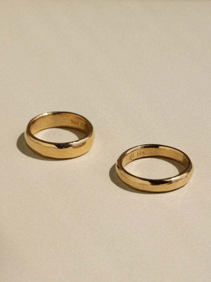 For those who appreciate the unique softness that comes from a hand crafted ring, we offer timeless gold bands carved just for you. Using only hand tools, we'll carve your ring in wax and then have it cast into gold using the ancient technique of lost wax casting. Our Sculpted Bands are made one at a time by traditional methods, show signs of their creation, and are truly one of a kind. The top of the band has a generously rounded dome, measuring a full 2mm in height, and the inside has a subtle Heirloom 14k Gold Wedding Band Thick Shape, Yellow Gold Thick Band Jewelry For Promise, Yellow Gold Promise Jewelry With Thick Band, Yellow Gold Thick Band Promise Jewelry, Heirloom Yellow Gold Wedding Ring With Thick Band, Classic Hand Forged Signet Ring For Anniversary, Timeless Thick Band Promise Jewelry, Heirloom Hand Forged Round Band Rings, Gold Hand Forged Round Band Rings