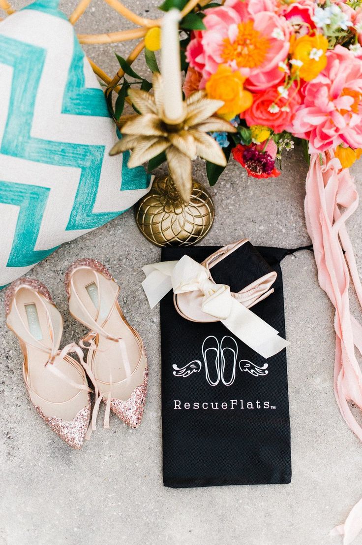 the shoes are sitting on the ground next to some flowers and a black bag that says beauouflaise