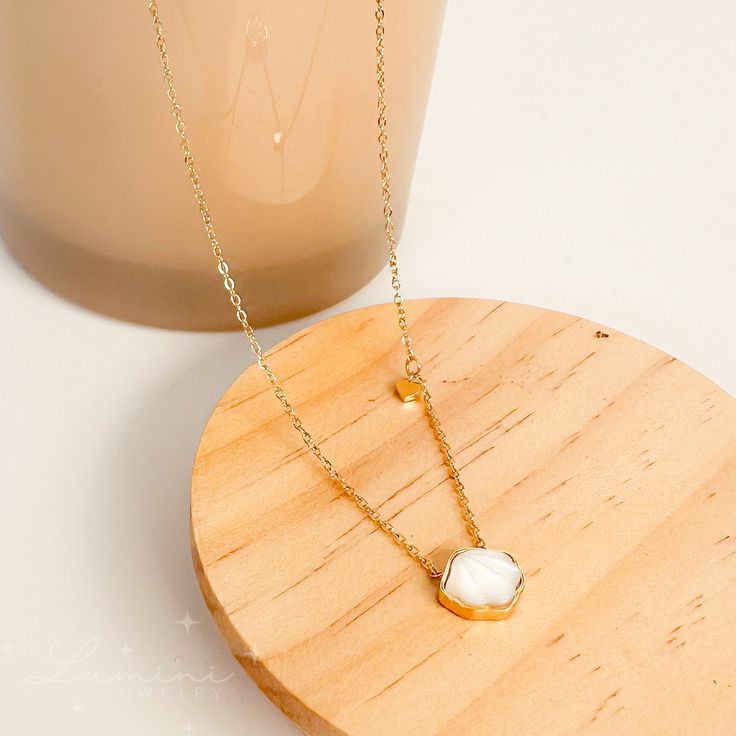 Go ahead and make a statement without saying a word with this cute and dainty Snow Shell Necklace! The tiny heart charm attached gives the necklace that subtle elegance. Material: 18k gold plated on stainless steel Pendant: Natural cowrie shell Length: White Gold Plated Charm Necklace With Adjustable Chain, White Gold-plated Charm Necklace With Adjustable Chain, Dainty White Pearl Pendant Charm Necklace, Minimalist White Charm Necklace With Delicate Chain, Everyday White Clavicle Chain Charm Necklace, Dainty White Clavicle Chain Charm Necklaces, Dainty White Charm Necklace With Clavicle Chain, Dainty Stainless Steel Charm Necklace For Her, White Tarnish-resistant Charm Necklace